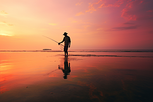 海边赶海礁石夕阳摄影图