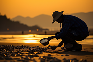 海边赶海渔获夕阳摄影图