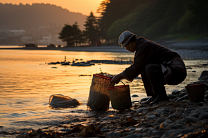 海边赶海捕捞落日摄影图