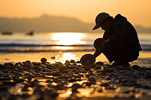 海边赶海落日潮汐摄影图