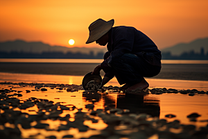 海边赶海夕阳落日摄影图