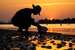 海边赶海落日滩涂摄影图