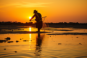 海边赶海礁石夕阳摄影图