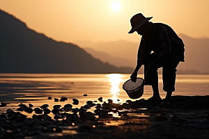 海边赶海落日滩涂摄影图