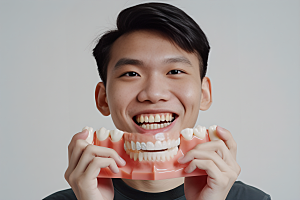 牙科广告人物看牙医假牙模型摄影图