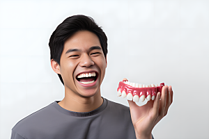牙科广告人物牙科诊所假牙模型摄影图
