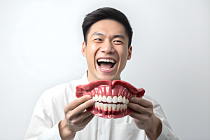 牙科广告人物科普假牙模型摄影图